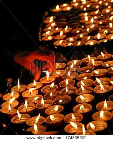 Person Lights A Candle During The Ceremony