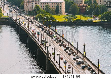 Riga, Latvia. Traffic On The Akmens Tilts - Stone Bridge Street In Summer Day. Top View