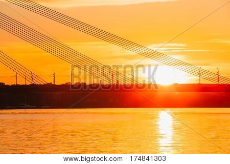 Riga, Latvia. Scenic View Of Vansu Cable-Stayed Bridge Over The Daugava River, Western Dvina In Bright Sunset Or Sunrise Time
