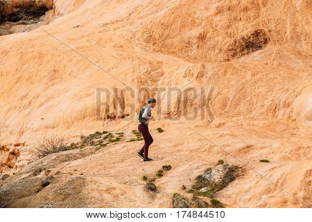 Mtiuleti Region, Georgia - May 21, 2016: Tourist Man Comes To Roadside Springs. Red Mineral Water Contains A Lot Of Iron.