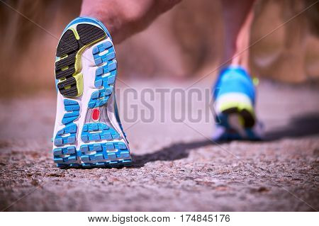 Foot closeup athlete running in sneakers outdoors.