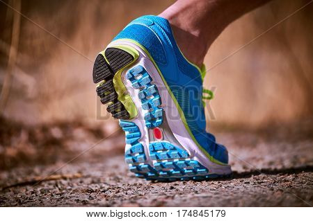 Foot closeup athlete running in sneakers outdoors.