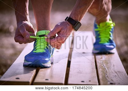 Tying shoelaces on sneakers during class outdoor sports.