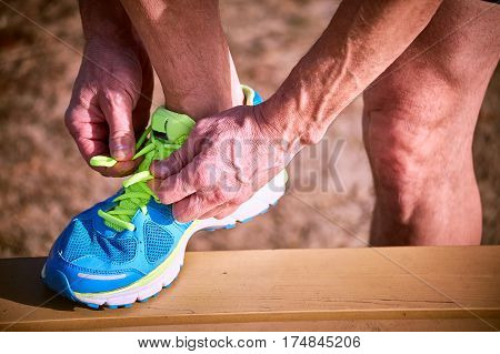 Tying shoelaces on sneakers during class outdoor sports.