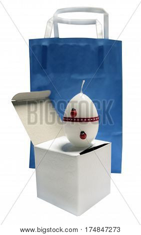 white candle on a blue package isolated the white background