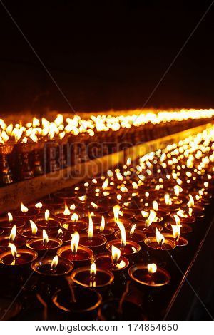 Many Candle Flames Glowing In The Dark