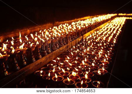 Many Candle Flames Glowing In The Dark
