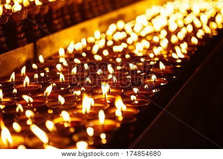 Many Candle Flames Glowing In The Dark