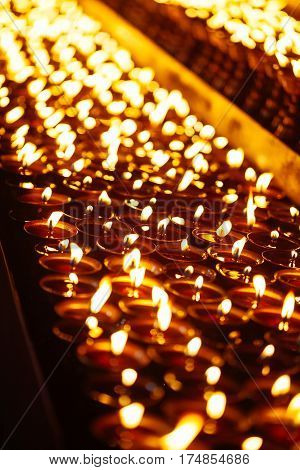 Many Candle Flames Glowing In The Dark