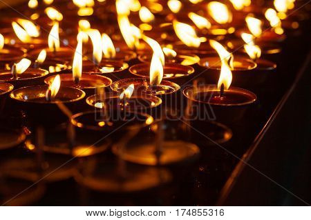 Many Candle Flames Glowing In The Dark
