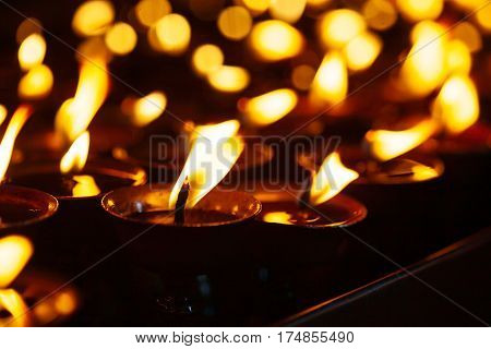 Many Candle Flames Glowing In The Dark