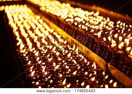 Many Candle Flames Glowing In The Dark