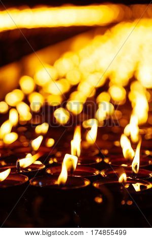 Many Candle Flames Glowing In The Dark