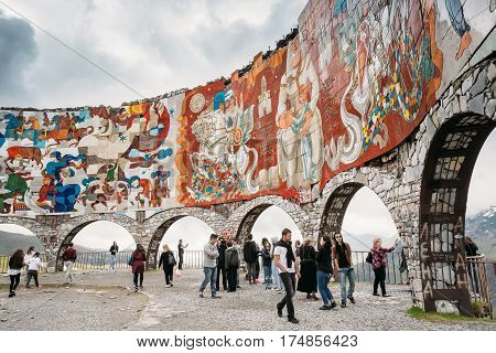 Mtiuleti Region, Georgia - May 21, 2016: People Visiting Friendship Arch In Kazbegi. Famous Landmark In Gudskoye Gorge In Georgia. Viewing Platform In The Distant 1983.