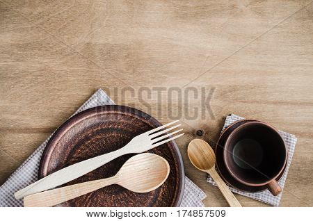 Rustic Kitchen Utensils: the Ceramic Plates and Wooden Cutlery on Wooden Background. Home Wares. Kitchen Decor in Rustic Style. View From Above With Copy Space.