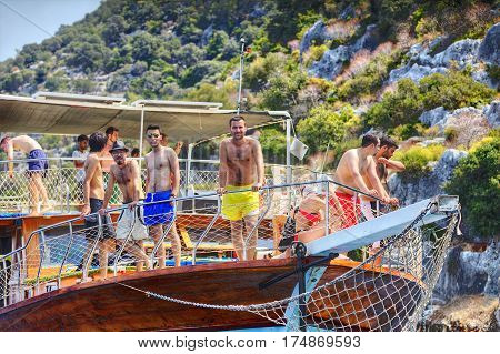 Antalya Turkey - 28 august 2014: Turkish Yacht vacation on Mediterranean Sea many tourists stand on the deck at the bow of the boat excursion.