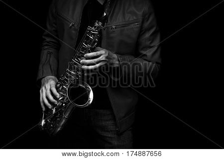 male jazz saxophone player on the stage with leather jacket black and white color