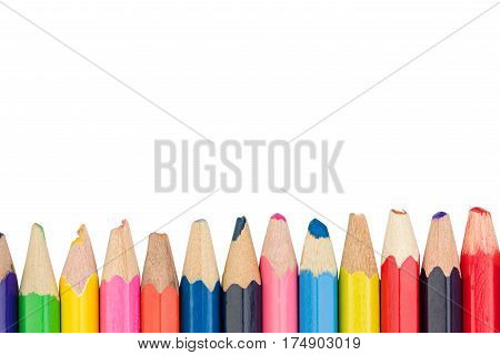 Colored pencils arranged in a row with space for text at the top