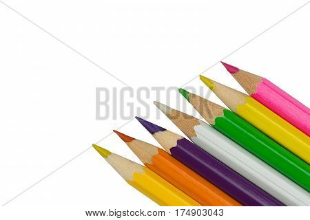 Sharp colored pencils in the right corner on a white background