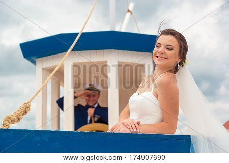 Wedding couple on small boat. The bride and groom on the ship.