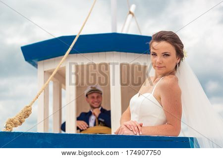 Wedding couple on small boat. The bride and groom on the ship.