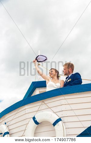 Wedding couple on small boat. The bride and groom on the ship.