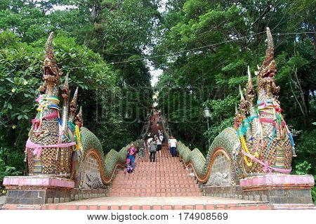 Travelers foreigner and thai people walking at stairs for entrance go to Wat Phra That Doi Suthep for praying on June 5 2011 in Chiang Mai Thailand.