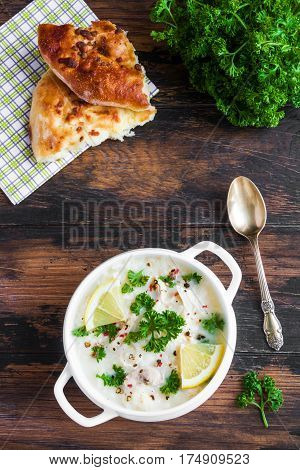 Avgolemono, Chicken Soup With Egg-lemon Sauce, Rice And Fresh Parsley Leaves In White Bowl And Fresh