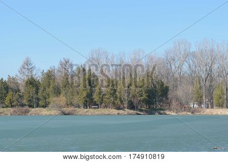 Frozen lake in spring time at Memorial Park Constantin Stere in Bucov near Ploiesti Romania