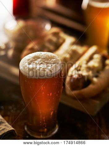 freshlly poured IPA beer in mug served with bratwursts