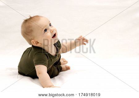 Portrait of cute open-mouthed 9-month-old toddler. Horizontal studio shot. Copy space