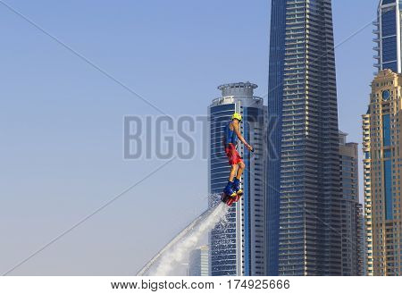 Extreme sportsman on flayborde climbs to perform tricks in the competitions in extreme sports in Dubai