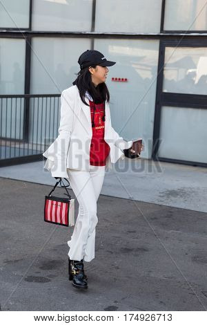 MILAN ITALY - FEBRUARY 25: Fashionable woman poses outside Antonio Marras fashion show during Milan Women's Fashion Week on FEBRUARY 25 2017 in Milan.