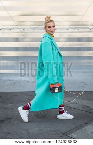 MILAN ITALY - FEBRUARY 25: Fashionable woman poses outside Antonio Marras fashion show during Milan Women's Fashion Week on FEBRUARY 25 2017 in Milan.