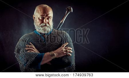 Powerful Bearded Knight With The Sword On The Dark Background