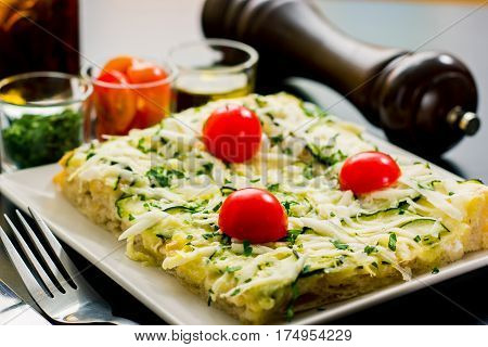Delicious Square of pizza served and some ingredients