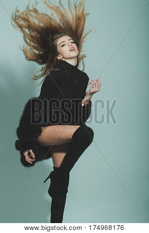 Pretty Sexy Woman With Long Hair In Fur And Jackboot
