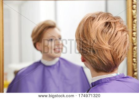 Young woman with trendy hairstyle at beauty salon