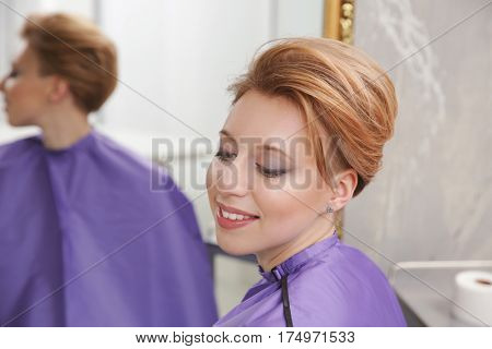 Young woman with trendy hairstyle at beauty salon