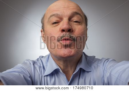 Elderly Relative Pulled Forward His Lips, Trying To Hug And Kiss Someone