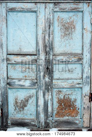 Vintage old blue wooden door with cracked paint