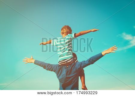 father and little son having fun on sky