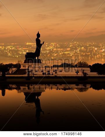double exposure Buddhist park in Phutthamonthon over cityscape in Sunset.