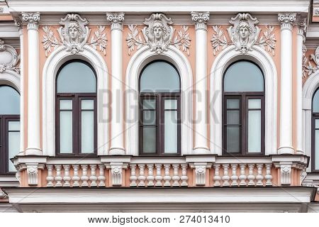 Three Arched Windows Against A Wall Of Pink Color With A Bas-relief And Columns. From The Series Win