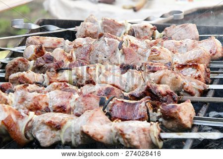 Shish Kebabs Are Fried On A Brazier With Firewood And On Coals. Shish Kebabs On Skewers. Meat Shish 