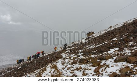 Group Of Climbers Climbing The Sand In The Volcano Iliniza North On A Cloudy Day