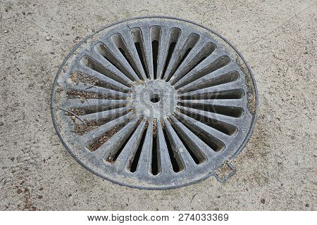 Metal Hatch Of The Well Is Closed. Hatch For Water.asphalt Around.