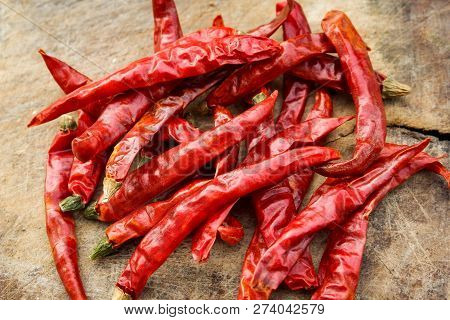 dried red chili on wooden / pile of dry red chilli peppers on old wood background