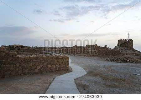 The Tallest Tower Of Masada Against The Cloudy Sky At Dawn In The Sun. Historical Excavations On The
