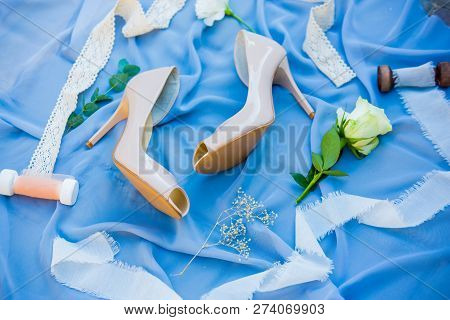 Wedding Shoes. Footwear. Wedding Accessories Of The Bride. Photo Of A Bride Shoes On A Blue Backgrou